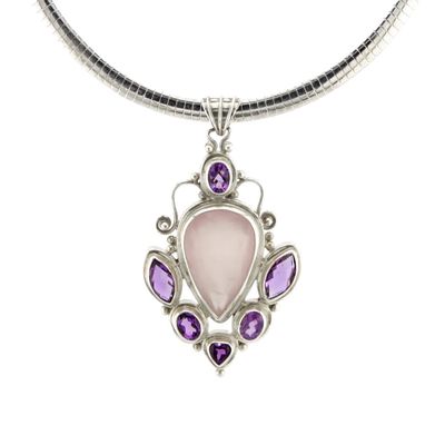 Necklace with a pendant featuring a pink stone and purple gemstones on a white background