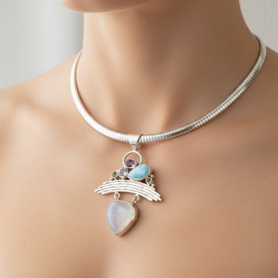 Multicolored gemstone necklace with silver pendant on a white background